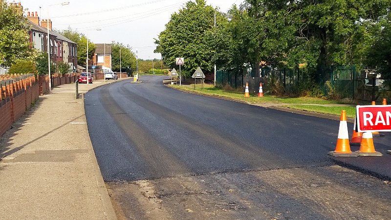 789-This view.jpg - 789-This view shows the extent of resurfaced roadway through the village at the end of the first day. 